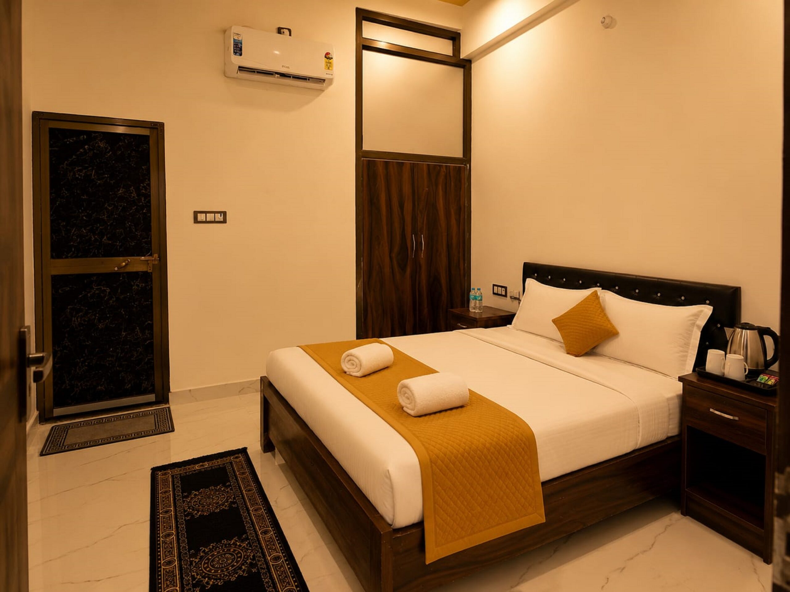 Clean and comfortable deluxe room at The Awadh Select hotel in Ayodhya with AC and modern amenities